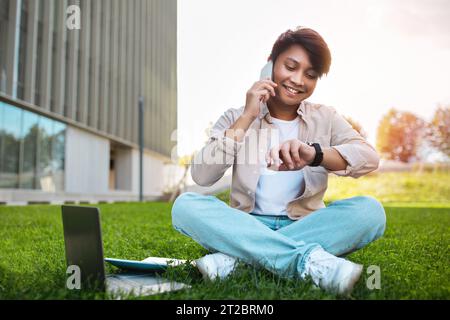 Busy young asian man digital nomad working at public park Stock Photo