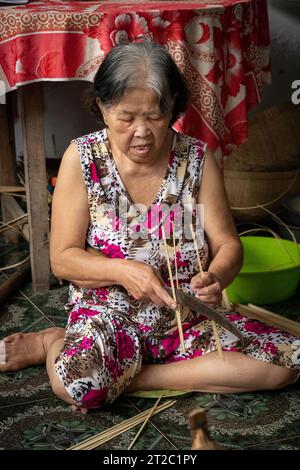 Splitting Bamboo for Weaving Baskets, Mekong Delta, Vietnam Stock Photo