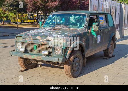 A car after a gun attack. On broken, burned cars, a close-up shot of areas and holes from shelling and shrapnel after the Russian invasion of Ukraine. Stock Photo