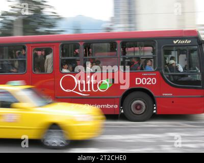 Quito, Ecuador - April 3, 2006: Red bus and yellow taxi in Quito Ecuador South America Stock Photo