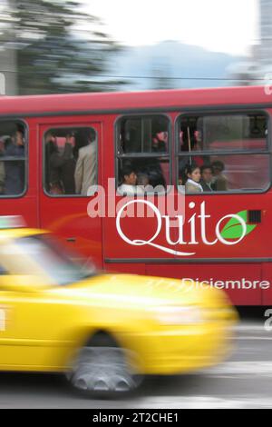 Quito, Ecuador - April 3, 2006: Red bus and yellow taxi in Quito Ecuador South America Stock Photo