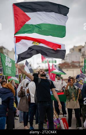 Lisbon, Portugal. 18th Oct, 2023. An activist is seen carrying Palestinian and Egyptian flags, during a demonstration. The rally calling for a ceasefire and an end to the Israeli-Palestinian conflict was organized by the Portuguese Council for Peace and Cooperation and the Movement for the Rights of the Palestinian People. Credit: SOPA Images Limited/Alamy Live News Stock Photo