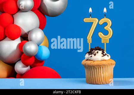 Number 73 birthday candle - Anniversary card with balloons Stock Photo