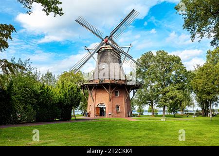 Old windmill in spa park with big tree, Bad Zwischenahn, Lower Saxony, Germany Stock Photo