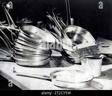 Lunch for Goering; in foreground is noon meal ready to be taken to the former chief of the Luftwaffe. It consists of three pieces of brown bread (about 150 grams), one cup (and only one) of coffee, about 200 grams of dehydrated eggs, and a goulash (stew) of about 200 grams. Dining equipment consists of a spoon, canteen cup without handle, and a GI meat can. In the background are the mess kits for other prisoners standing trial before the International Military Tribunal at Nuremberg Stock Photo