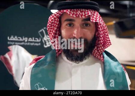 File photo - French football player Karim Benzema is seen dancing the traditional ‘aardha’, sometimes also known as the sword dance’, as he celebrates with his club ‘Al-Ittihad’, the Saudi National Day (September 23), in Jeddah, Kingdom of Saudi Arabia, on September 27, 2023. Benzema is wearing traditional Saudi clothes : a ghutra or keffieh on his head, a white dishdasha or thobe. 2022 Ballon d’Or winner Karim Benzema finds himself mired in political controversy amid the ongoing Israel-Hamas war. Speaking to French outlet CNews on Monday, French Interior Minister Gérald Darmanin accused Benze Stock Photo