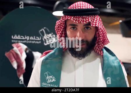 File photo - French football player Karim Benzema is seen dancing the traditional ‘aardha’, sometimes also known as the sword dance’, as he celebrates with his club ‘Al-Ittihad’, the Saudi National Day (September 23), in Jeddah, Kingdom of Saudi Arabia, on September 27, 2023. Benzema is wearing traditional Saudi clothes : a ghutra or keffieh on his head, a white dishdasha or thobe. 2022 Ballon d’Or winner Karim Benzema finds himself mired in political controversy amid the ongoing Israel-Hamas war. Speaking to French outlet CNews on Monday, French Interior Minister Gérald Darmanin accused Benze Stock Photo