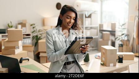 Small business, woman and tablet for e commerce, startup and inventory management of online shop, order or courier. Entrepreneur or Indian seller on Stock Photo