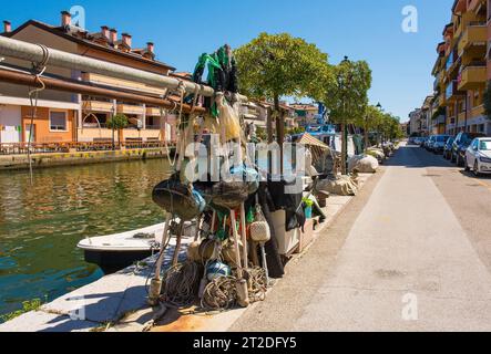 Grado, Italy - August 11th 2023. Fishing equipment and boats on the waterfront of Grado in Friuli-Venezia Giulia, north east Italy Stock Photo