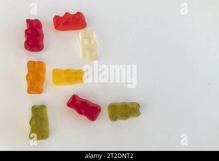 The letter R made from beautiful sweet delicious multi-colored chewy juicy fruit gummy candies of bears on a white background. Sweet alphabet. Stock Photo