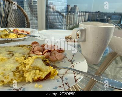 Breakfast of eggs omelette with sausages on a beautiful plate. Stock Photo