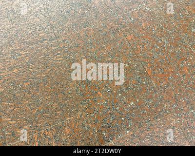 The texture of the stone granite floor of cold hard tiles. The background. Texture. Stock Photo