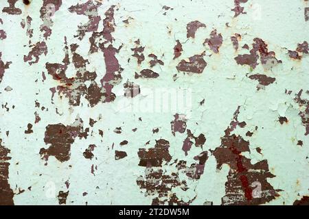 Texture of rusty two-color reddish and green old shabby oxidized metal, iron with bulbted peeling and green paint and patterns, background. Stock Photo