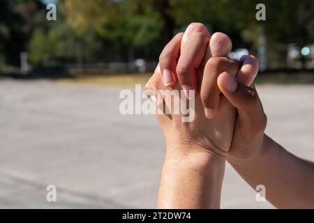 Hands of different ethnicities, African and European, together hugging each other. Union concept Stock Photo