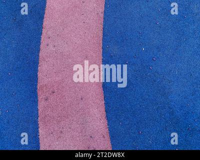 Blue and purple texture of the soft rubber surface of the safe cover of the sports playground for workout made of pressed fine rubber. The background. Stock Photo