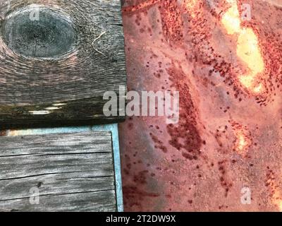 metal and wood texture. a strip of gray wood with a round hole lies next to a corroded sheet of metal. two materials, home creation. texture of natura Stock Photo