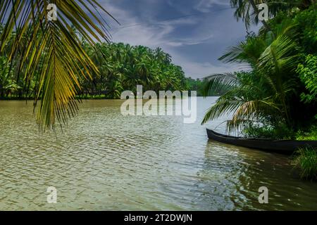 Beautiful backwater of Kerala, passengers travelling on a wooden boat to next town Stock Photo