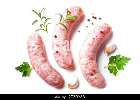 Raw sausages with spices, garlic, rosemary isolated on white background. Cooking ingredients. Natural healthy food concept, top view. Stock Photo