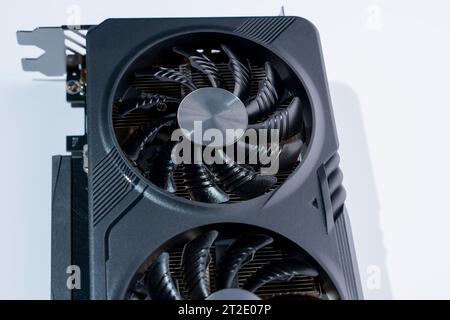 a modern powerful gaming graphics card for a computer with three fans. the concept of PC hardware. Gaming video card Stock Photo