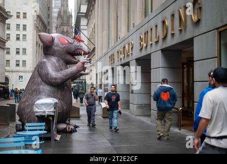 New York, NY, USA 10-06-2023 Pedestrians walk by giant inflatable evil rat on sidewalk in front of Trump Building Manhattan Stock Photo