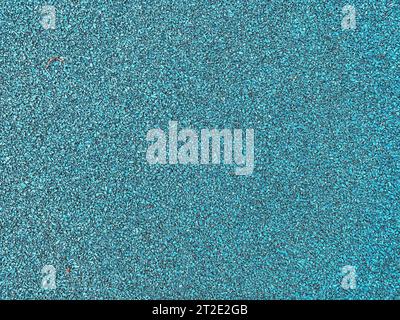 texture, background. emerald color rubberized sports ground cover. anti-slip running surface. safety during outdoor activities. Stock Photo