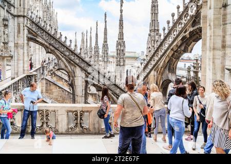 MILAN, ITALY - MAY 17, 2018: Unidentified tourists are visiting the Milan Cathedral on its roof. Stock Photo