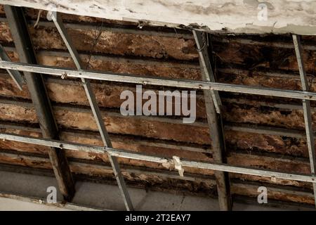 Ceiling panels had damaged a large hole in the roof from a rainwater leak. Ceiling damaged by water. The ceiling broke down Stock Photo