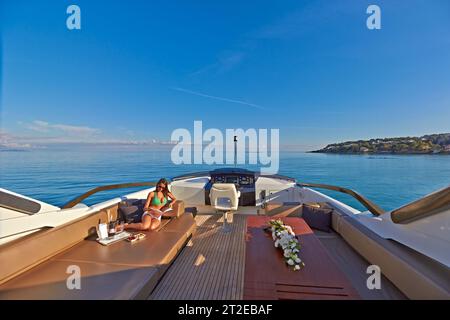 Lady relaxing on the Sundeck of a Charter Yacht in the South of France. Stock Photo