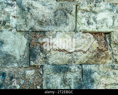 texture. stone wall with thickets of moss and grass. concrete structure. bricks for building construction. 3d volumetric texture, background. Stock Photo