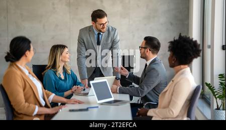 Team leader discussing and brainstorming new approaches and ideas with colleagues. Stock Photo