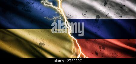 Concept of the armed conflict between Ukraine and Russia with waving dirty flags and lightning bolt with flash through the center. Stock Photo