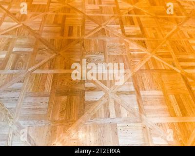 Texture of brown textured yellow wooden floor, parquet of small rectangular plates, lacquered wood plank boards. The background. Stock Photo