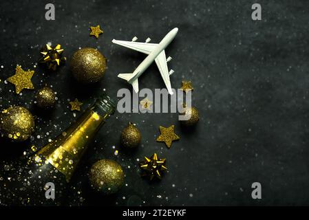 https://l450v.alamy.com/450v/2t2eykf/christmas-concept-background-champagne-bottlechristmas-ballssparkling-glitter-and-plane-with-space-for-text-on-gray-background-christmas-travel-co-2t2eykf.jpg