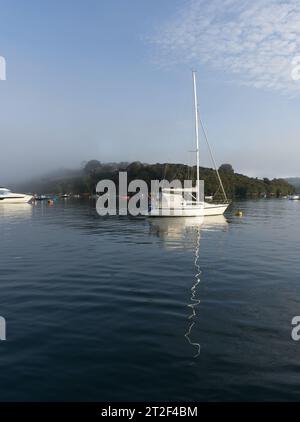 Yachts and reflections on a calm foggy morning in Salcombe Harbour Stock Photo