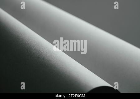 Gently curving paper with strong contrast in black and white Stock Photo