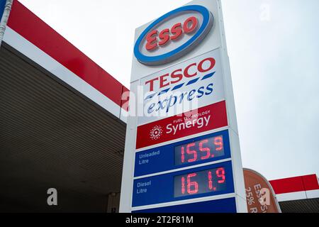 London- October 2, 2023: Esso fuel station and Tesco Express sign with fuel prices in Fulham, south west London Stock Photo