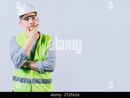 Pensive male engineer with hand on chin isolated. Pensive man engineer looking side. Portrait of handsome engineer thinking with hand on chin Stock Photo