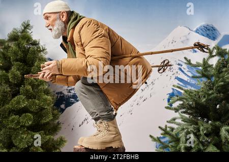 sporty bearded man dressed like Santa squatting with ski poles posing in profile, winter concept Stock Photo