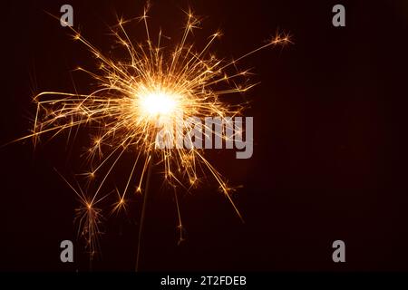 photo burning Christmas sparkler isolated on black background. glowing, copy space, horizontal, abstract Stock Photo