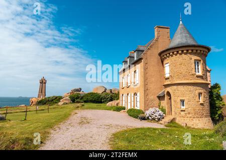 Beautiful house next to the Mean Ruz Lighthouse, port of Ploumanach, in the town of Perros-Guirec, Cotes-d'Armor, in French Brittany, France Stock Photo