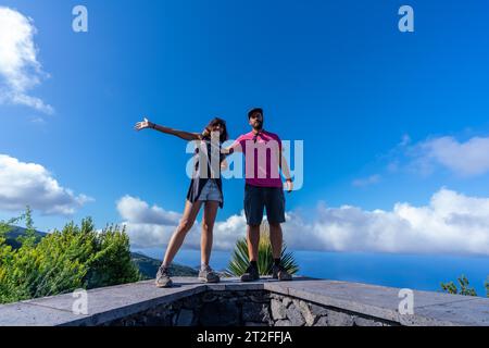 A very happy couple on top of the mountain at the viewpoint of the Cubo de la Galga natural park on the northeast coast on the island of La Palma Stock Photo