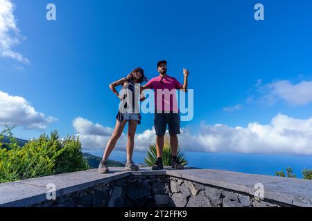 A very happy couple on top of the mountain at the viewpoint of the Cubo de la Galga natural park on the northeast coast on the island of La Palma Stock Photo