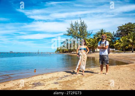 Two young men on the beach of Sandy Bay on Roatan Island. Honduras Stock Photo