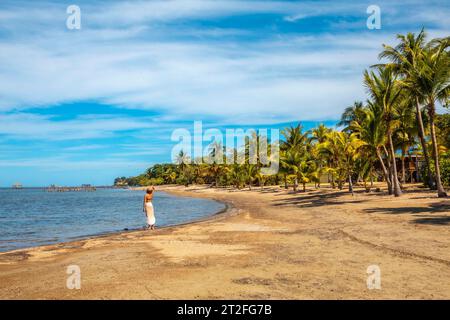 A young tourist on the beach of Sandy Bay on Roatan Island. Honduras Stock Photo