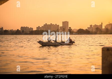 A family of local fishermen at sunset on the Nile river with the city of Cairo in the background. Africa Stock Photo