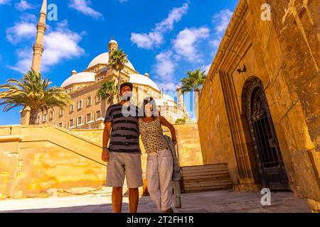 A couple of tourists enjoying the visit to the Alabaster Mosque in the city of Cairo, the capital of Egypt. Africa Stock Photo