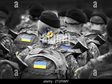 Woman soldier. Woman in army. Ukrainian flag on military uniform. Ukraine troops. Stock Photo