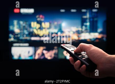 Watching movie stream service on tv. Video on demand subscription service and platform in television. Streaming series, films and shows online. Stock Photo