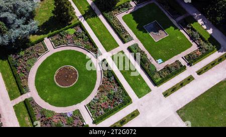 Stadtpark in Hamburg Drone point of view. Rose blossoms and small fountain in left corner. Flowers in geometrical order flowerbeds and meadows, garden Stock Photo