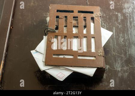Mailbox full of letters on the door Stock Photo